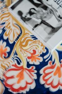 a plate of cookies with a picture of a woman at Villa Helios Capri - Small Luxury Hotels of the World in Capri