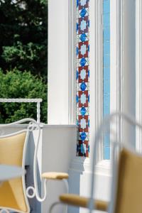 a room with a window with a chair and a tiled window sill at Villa Helios Capri - Small Luxury Hotels of the World in Capri +39 photos