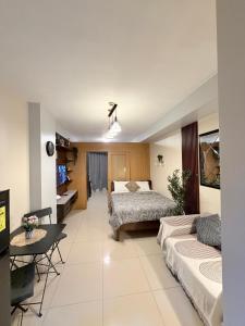a bedroom with two beds and a living room at Shell Residences Staycation MOA & NAIA by Keith in Manila +18 photos
