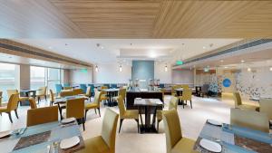 a dining room with tables and chairs in a restaurant at Svelte Delhi, a member of Radisson Individuals in New Delhi