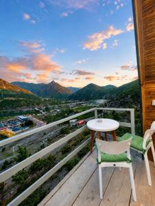 a table and two chairs on a balcony with a view at Guest house Panorama in Koman
