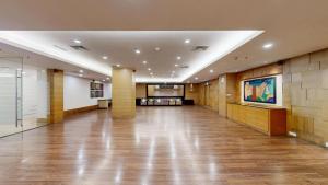 a large hallway with wooden floors in a building at Svelte Delhi, a member of Radisson Individuals in New Delhi +71 photos