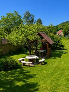 a park with a picnic table and a gazebo at Liliom Vendégház in Bakonybél