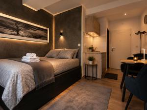 a bedroom with a bed and a table and a desk at Bellevue Residence l City Balkon in Koblenz