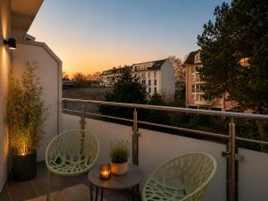 a balcony with two chairs and a table at Bellevue Residence l City Balkon in Koblenz