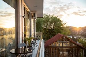 a balcony with a table and chairs on a building at AUTOGRAPH Kutaisi in Kutaisi