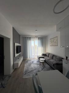 a living room with a couch and a table at ARMAS Stay in Kamëz