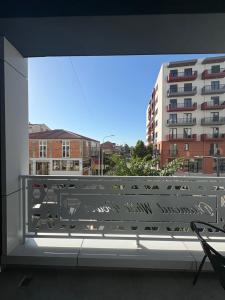 a large window with a view of a building at ARMAS Stay in Kamëz