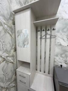 a bathroom with a white cabinet and a sink at Golden Emir Residence in Bukhara +43 photos