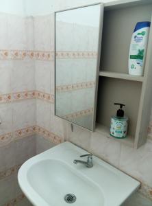 a bathroom with a sink and a mirror at Résidence cosy in Abidjan
