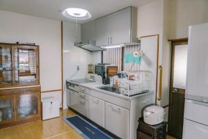 a kitchen with a sink and a counter top at 温泉街近くの一棟貸し ひだまり in Kirishima