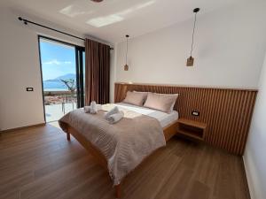 a bedroom with a bed with two towels on it at Filikuri Boutique Hotel in Himare +39 photos