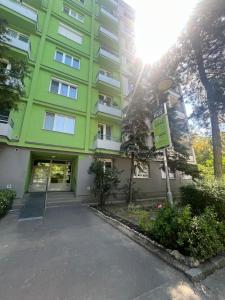 a green building with a street sign in front of it at Exnárova in Prievoz