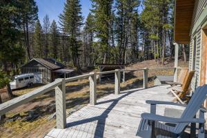 a wooden porch with chairs and a house at Off Grid Retreat Stay for 7 in Rexford