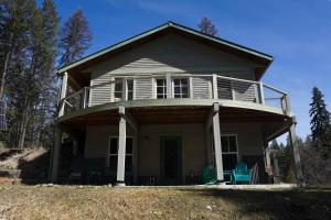 a small house with a porch and two blue chairs at Off Grid Retreat Stay for 7 in Rexford