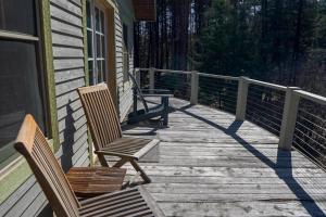 two chairs and a table on a wooden deck at Off Grid Retreat Stay for 7 in Rexford