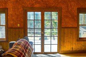 a living room with glass doors and a couch at Off Grid Retreat Stay for 7 in Rexford +30 photos