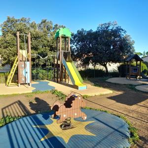 a playground with a slide in a park at Au refuge de Rolf in Calvisson