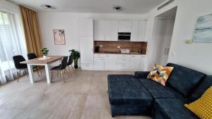 a living room with a couch and a table at Lavén Superior Apartment in Balatonfüred