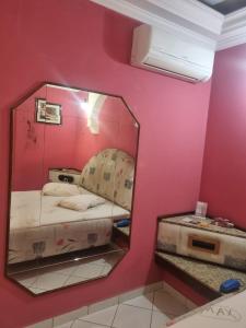 a mirror in a room with a bed in it at Max Motel in Jaguariúna