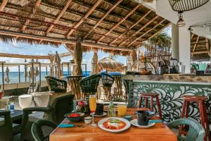 a restaurant with a table with food on it at Luciana Hotel & Beach Club in Playa del Carmen