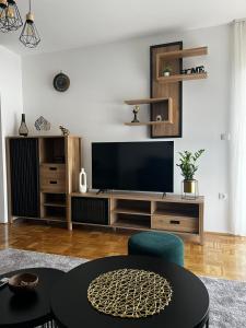 a living room with a flat screen tv at City Nest, Free Parking & City Center in Prijedor