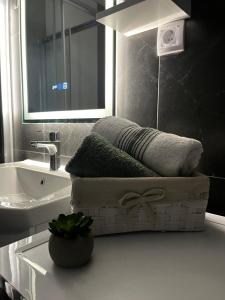 a bathroom with a sink and a bath tub with a towel at City Nest, Free Parking & City Center in Prijedor +7 photos