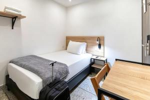 a hotel room with a bed and a table at Bianco Hotel Boutique in Cúcuta