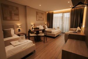 a hotel room with two beds and a table at SD Guest Villa in Krujë