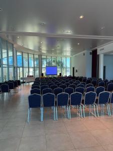 a large room with chairs and a screen at Palmar Hotel Casino in Concordia +123 photos