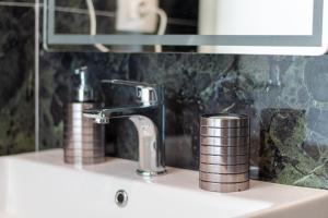 a sink with a faucet on top of it at D&D HOTEL Ksamil in Ksamil