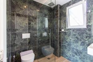 a bathroom with a toilet and a shower at D&D HOTEL Ksamil in Ksamil +127 photos