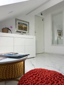 a white room with a red rug and a mirror at New apartman Summer in Kaštela +46 photos