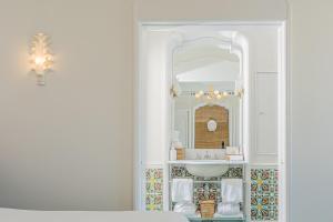a bathroom with a sink and a mirror at Villa Helios Capri - Small Luxury Hotels of the World in Capri
