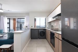 a kitchen with a washer and dryer in a room at Ballito Hills 478 in Ballito