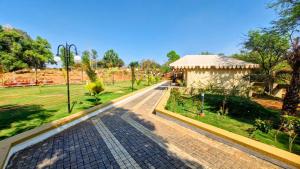 a walkway in a park with a gazebo at Whispering Woods in Gorthan
