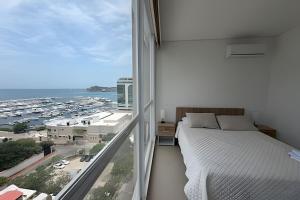 a bedroom with a bed and a large window at Eira by Colproperty Management in Santa Marta +176 photos