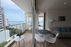 a living room with a couch and a table and chairs at Eira by Colproperty Management in Santa Marta