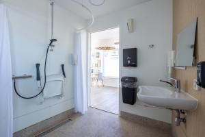 a bathroom with a sink and a shower and a mirror at Stadslogement Kingsize in Sneek +32 photos