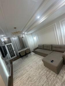 a living room with a couch and a table at Бахт in Bishkek