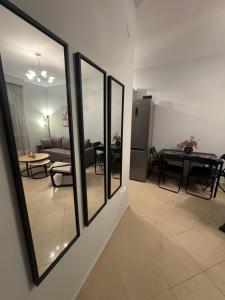 a living room with four mirrors and a table at Coastal Heaven in Neoi Epivates