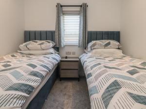 two twin beds in a bedroom with a window at Number 35 in Blackburn