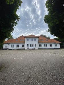 a large white building with red roofs at Sebber Kloster in Nibe