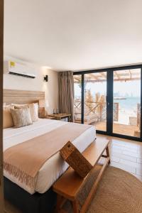 a bedroom with a large bed with a view of the ocean at Marazao Beach Hotel & Wellness in Tierra Bomba +55 photos