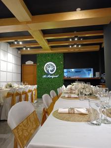 a dining room with white tables and white chairs at Xperience Hotel in Baños