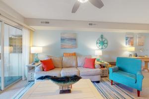 a living room with a couch and a blue chair at Mallard Lakes 158 Cardinal Ln in Selbyville +24 photos