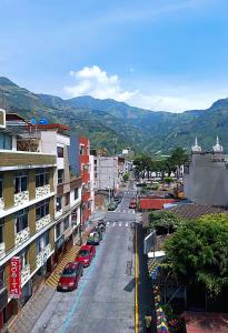 a city street with cars parked on the street at Xperience Hotel in Baños