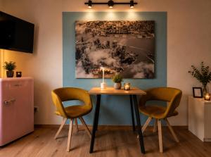 a dining room with a table and two chairs at Bellevue Residence l City Balkon in Koblenz