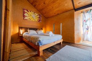 a bedroom with a bed in a wooden room at Sons do Eo- Apartamentos rurales sostenibles en Baleira Lugo in Baleira