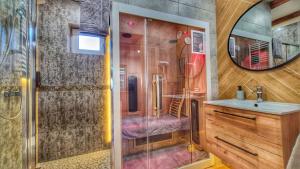 a bathroom with a shower and a sink at Urocza Kryjówka ze SPA in Lesko